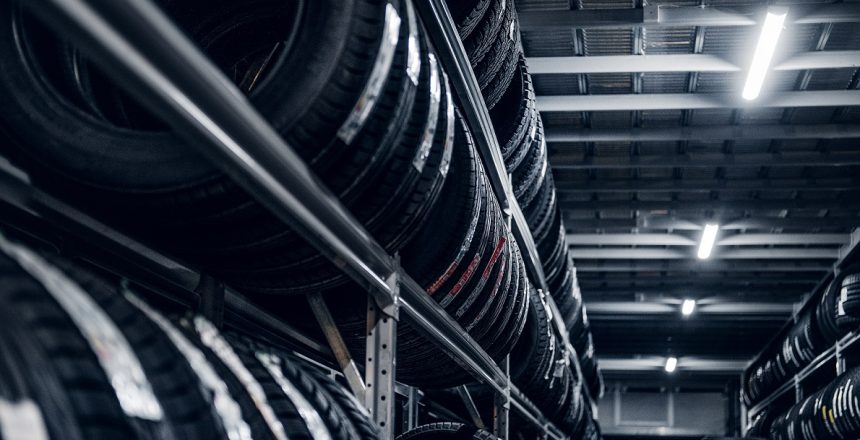 Dark storage full or big variety of new tyres at busy warehouse.