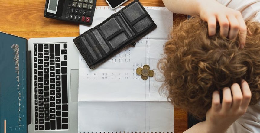 Portrait of caucasian unset and despair man watching financial and economical graphs during coronavirus quarantine, problems. Worldwide crisis.